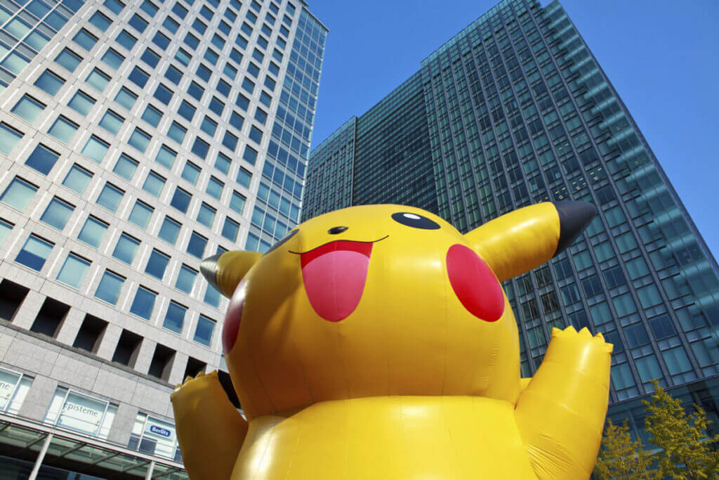 giant pikachu balloon in front of tall buildings
