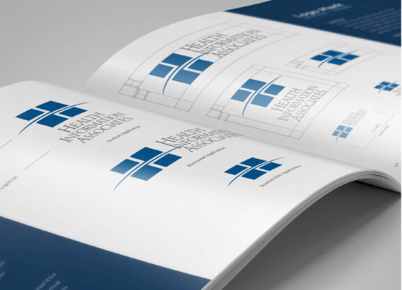Booklet flipped open to page containing logo options for Health Information Associates
