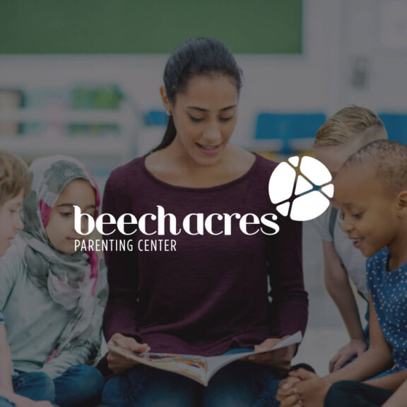 Image of a teacher reading to male and female students with a white beech acres parenting center logo in the middle of the image
