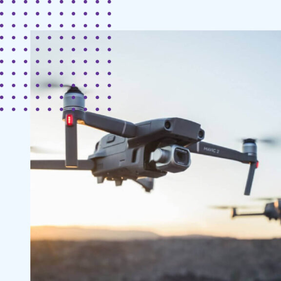 Image of a drone flying in the sky with a purple dotted icon in the top left corner