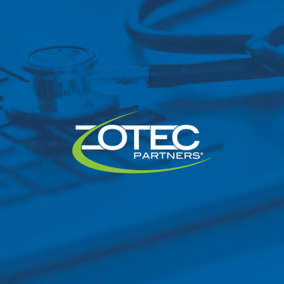 Image of a stethoscope sitting on a laptop keyboard with a blue filter over the image and a small white and green Zotec Partners logo in thecenter