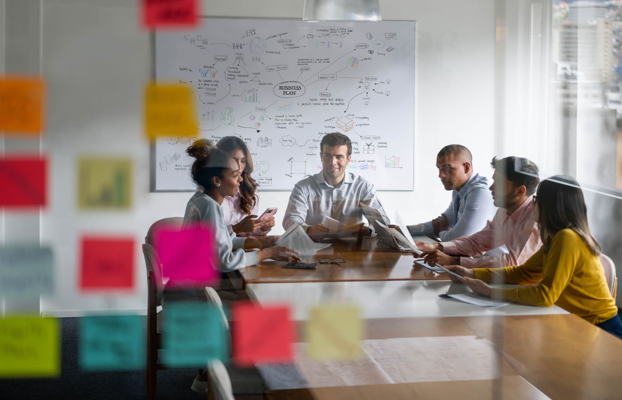 Photo of marketers sitting at a table discussing a social media business plan