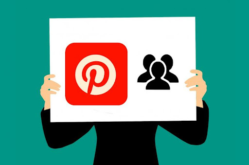 Green graphic with an illustration of a person’s hands holding a white sign with the Pinterest logo on it in front of them